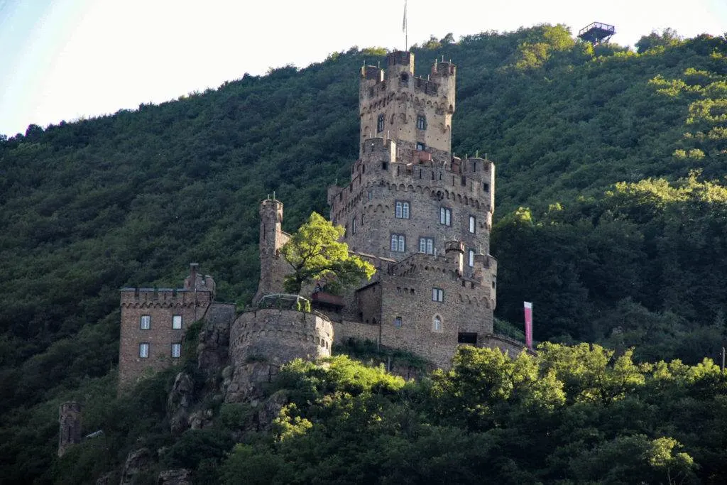 Do you love castles? Then you have to book a Rhine River Cruise. Cruising the Romantic Rhine is a great way to see these beautiful Medieval castles and vineyards. #rhinerivercruise #rhinevalley #germany #germancastles #castles 
