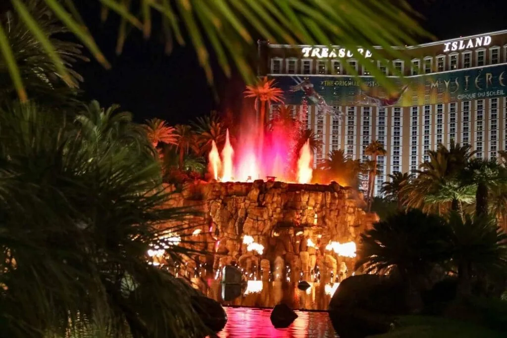 red and white flames shooting out of the top of a man made rock volcano at the Mirage Hotel in Las Vegas