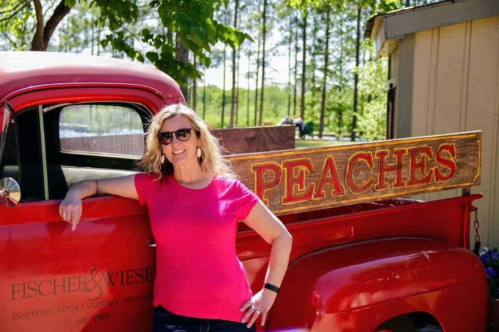girl by peach truck-one of the things to do in Fredericksburg TX
