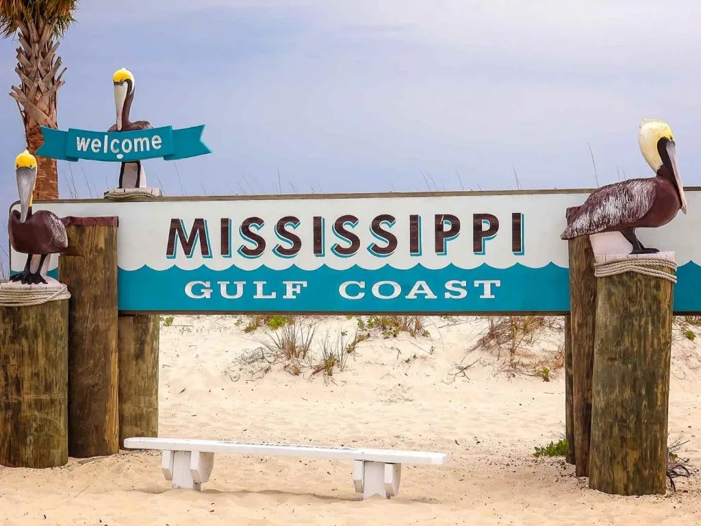 beach with welcome to mississippi gulf coast written on it