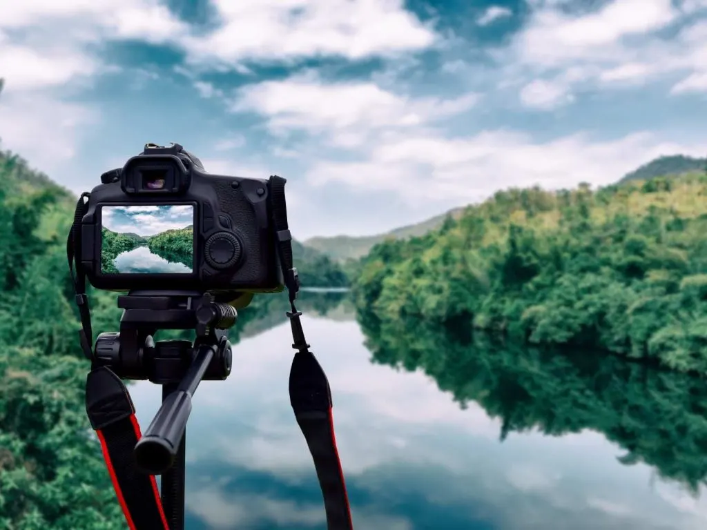 camera on a tripod taking a picture of a river