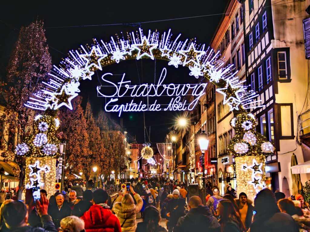 lighted arch sign reading "Strasbourg, Capital de Noel"